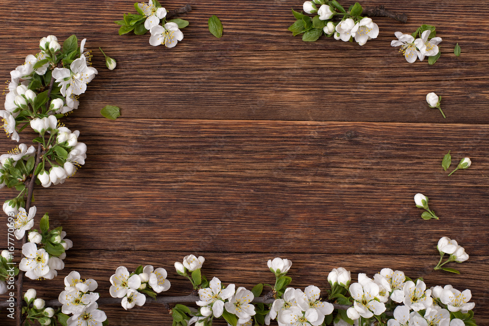 Spring flowers. Branches of a flowering plum on a brown table. Spring flowers. Branches of a flowering plum on a brown table.