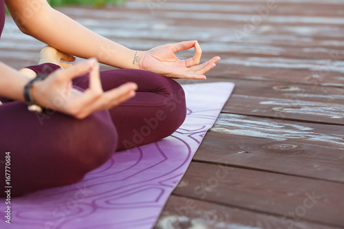 Close up of hands young woman meditates while practicing yoga outdoors. Freedom, Calmness and relax, woman happiness concept.