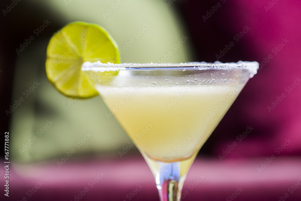 Yellow coctail with lime, margarita cocktail with salty rim Yellow coctail with lime, margarita cocktail with salty rim