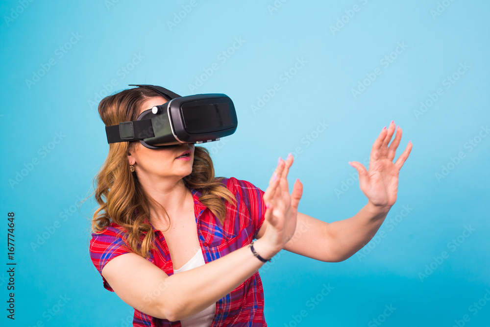 technology, virtual reality, entertainment and people concept - Woman with virtual reality goggles