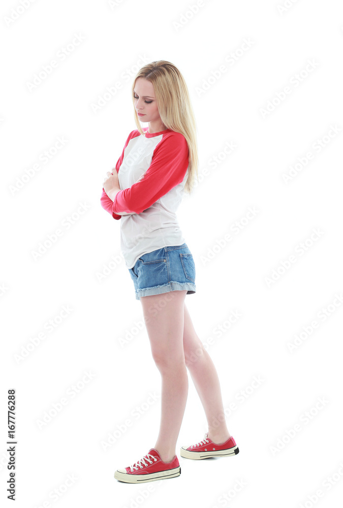 full length portrait of a blonde girl wearing casual t-shirt and denim shorts. isolated on white background. full length portrait of a blonde girl wearing casual t-shirt and denim shorts. isolated on white background.