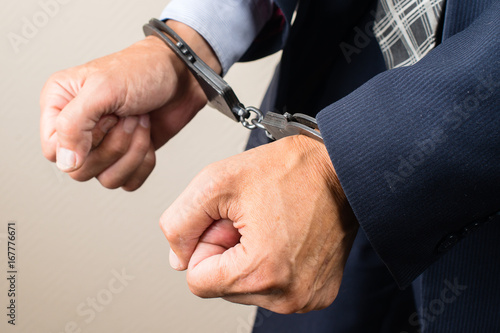 arrested businessman in handcuffs. Businessman bribetaker or briber. Concept of fraud, detention, crime and bribery