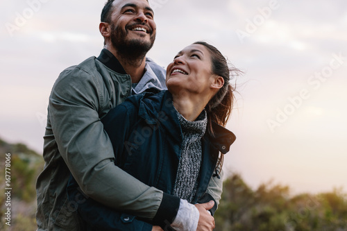 фотографія Romantic young couple embracing in nature