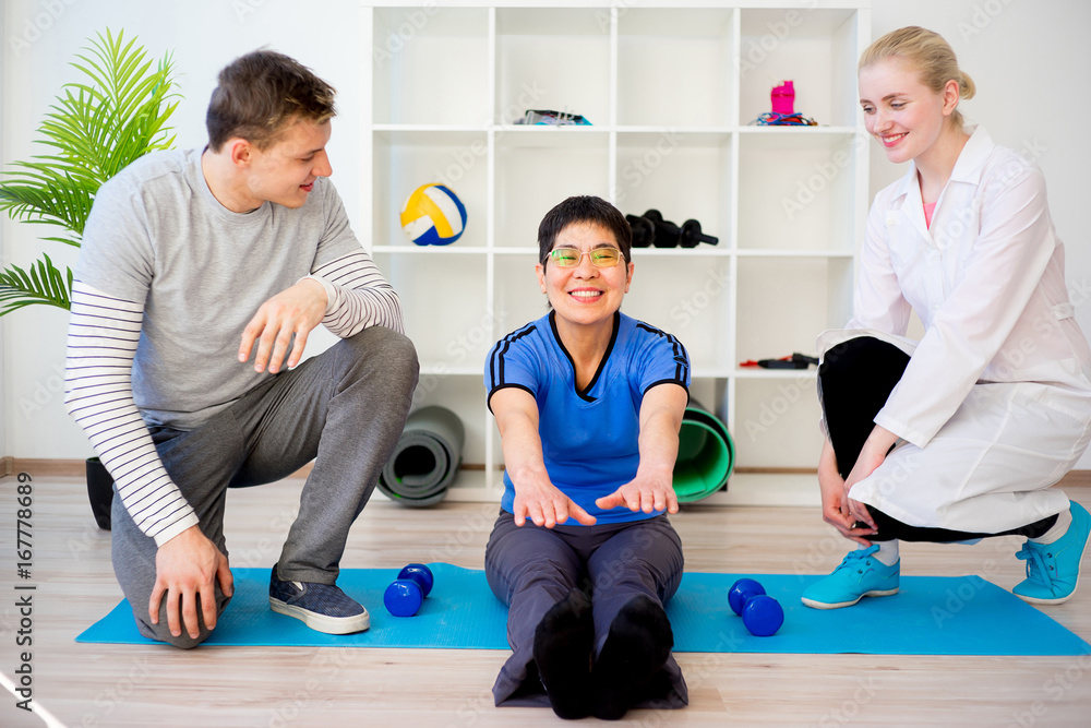 Physiotherapist helping a senior patient Physiotherapist helping a senior patient