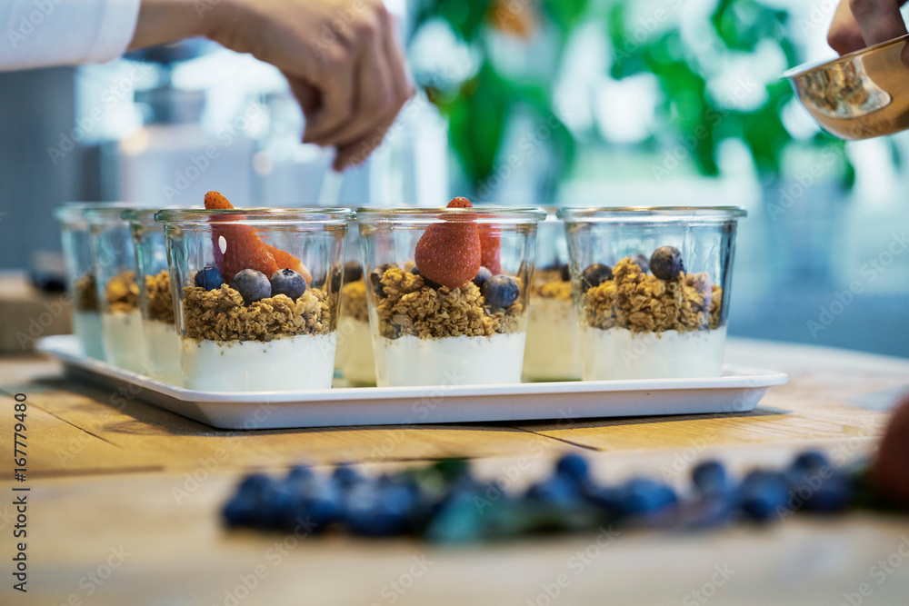 Chef preparing berry desserts, close-up Chef preparing berry desserts, close-up