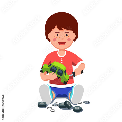 Boy mechanic repairing toy car using screwdriver