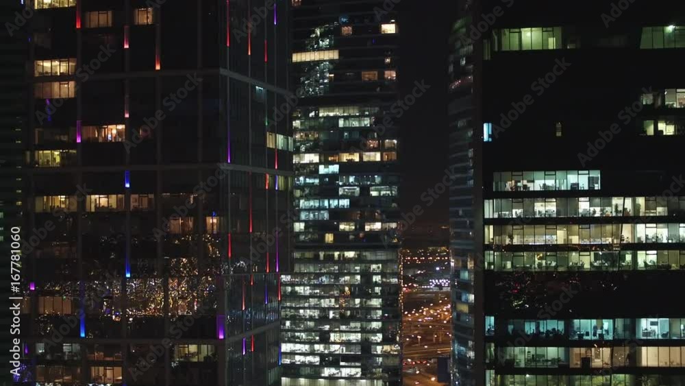 Unique Aerial flight around and approach to windows of Moscow City business center. Evening illumination. Offices from outside. Managers employees work. Quadcopter drone beautiful 4K shot Unique Aerial flight around and approach to windows of Moscow City business center. Evening illumination. Offices from outside. Managers employees work. Quadcopter drone beautiful 4K shot