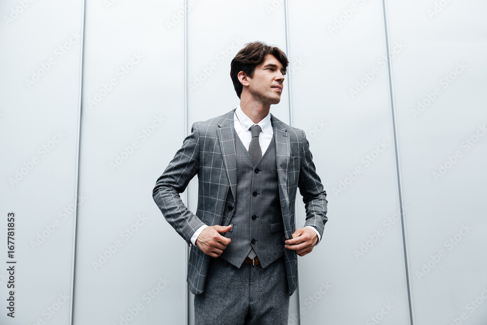 Young businessman in suit and necktie posing Young businessman in suit and necktie posing