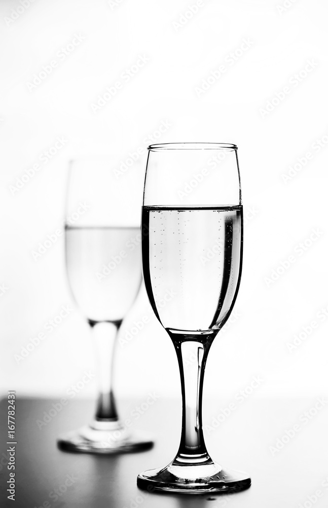 monochrome photo of champagne on white table on white background isolate