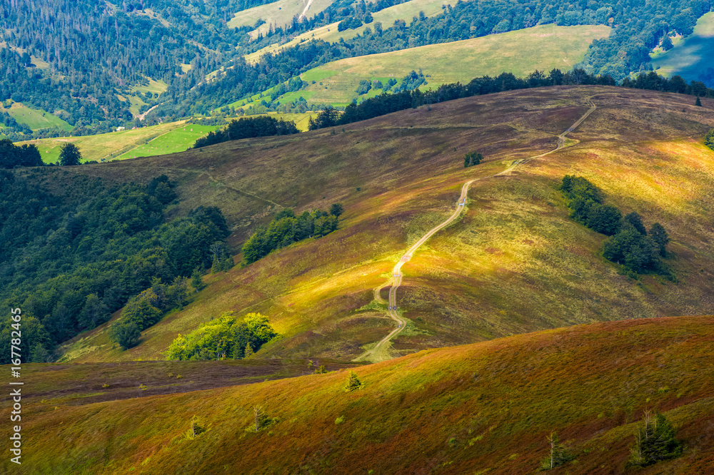 path down the grassy hillside to valley path down the grassy hillside to valley