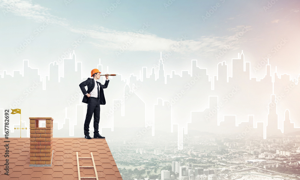 Engineer man standing on roof and looking in spyglass. Mixed med Engineer man standing on roof and looking in spyglass. Mixed med