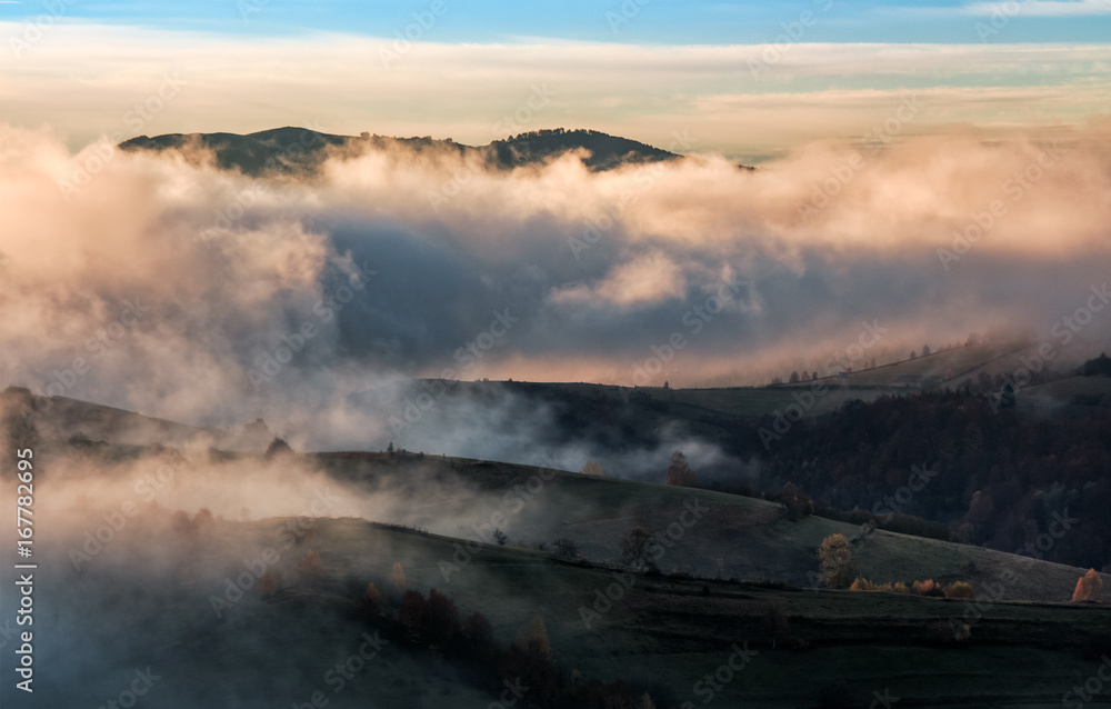 Fototapeta premium clouds and fog rising over countryside