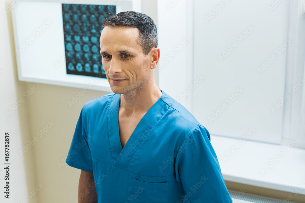 Handsome doctor standing in his CT scan lab Handsome doctor standing in his CT scan lab