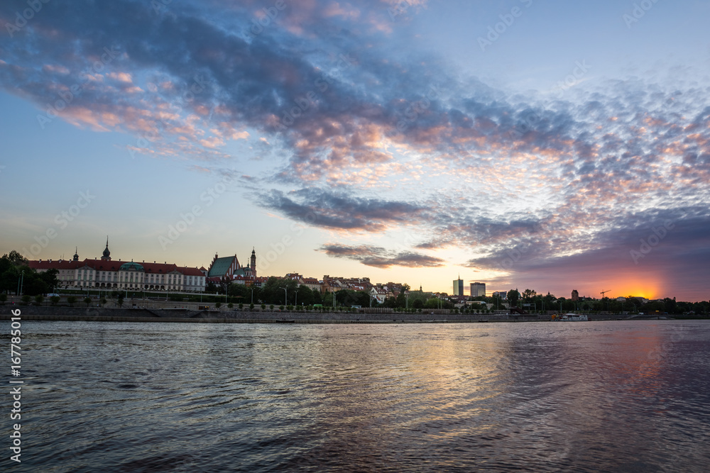 Sunset over the Royal Castle and Vistula river in Warsaw, Poland