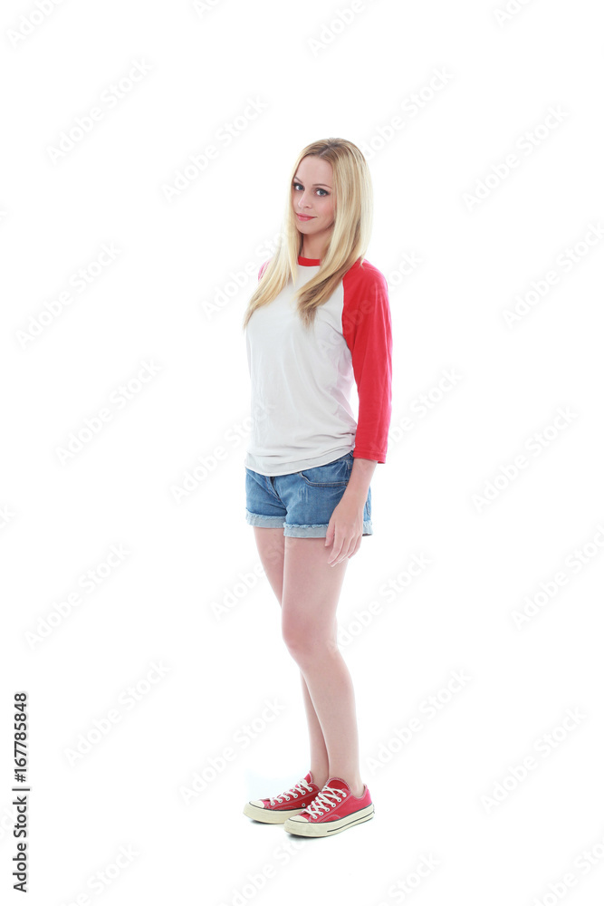 full length portrait of a blonde girl wearing casual t-shirt and denim shorts. isolated on white background. full length portrait of a blonde girl wearing casual t-shirt and denim shorts. isolated on white background.
