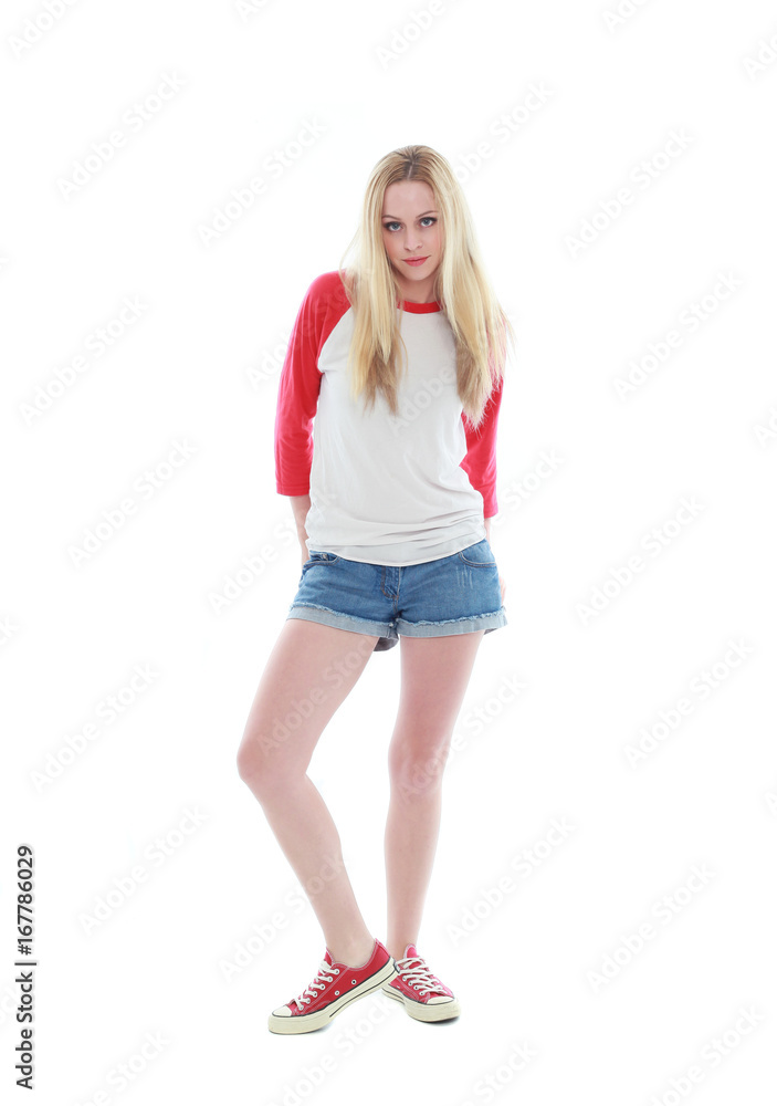 Fototapeta premium full length portrait of a blonde girl wearing casual t-shirt and denim shorts. isolated on white background.