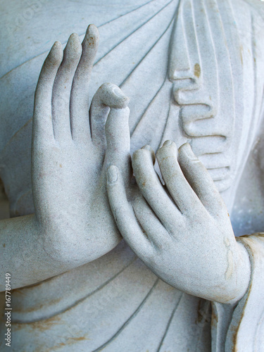 Obraz na płótnie Detail of a white statue of the Buddha with his hands. Fingers in mudra w salonie