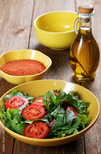 Vegetable salad with tomatoes and arugula on the table