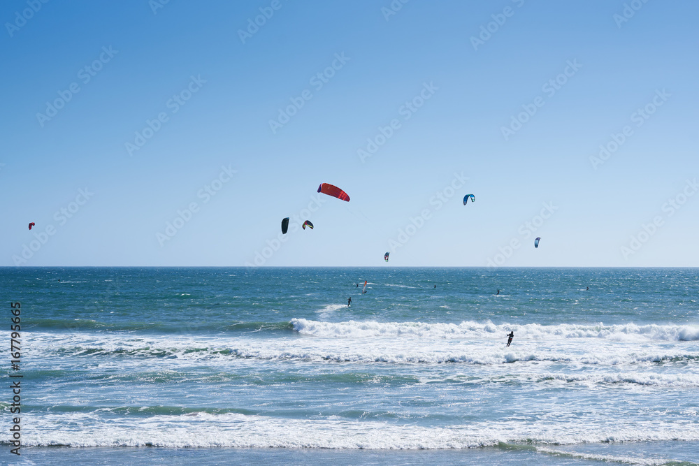 Remote view at kite surfers riding the waves in Santa Cruz, California Remote view at kite surfers riding the waves in Santa Cruz, California