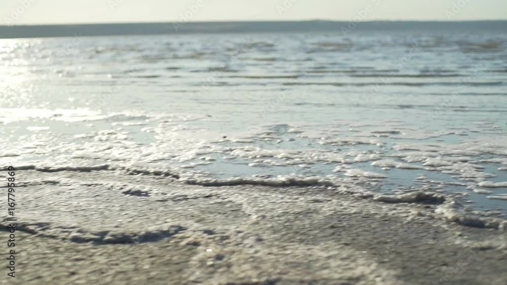 Close up dry sand sea foam beach seaside sunrise rapid slow motion Close up dry sand sea foam beach seaside sunrise rapid slow motion