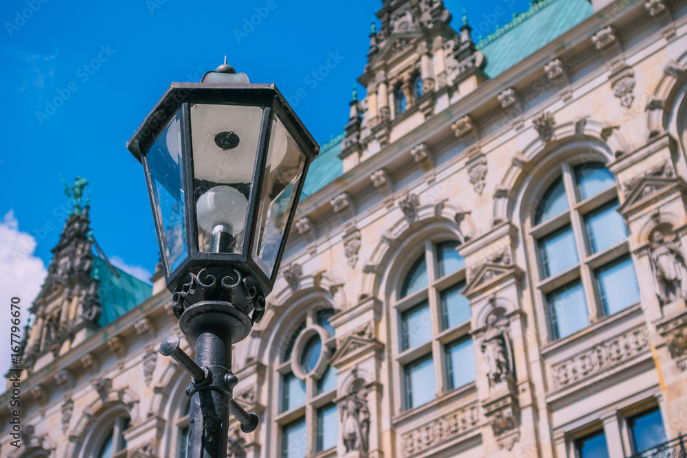 Old lantern in front od Hamburg City Hall Towers. Germany