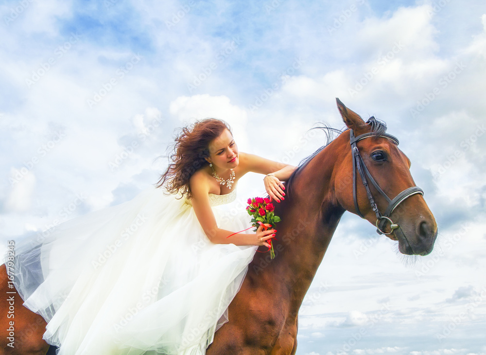 Fototapeta premium Beautiful bride, lying on a horse on her wedding day