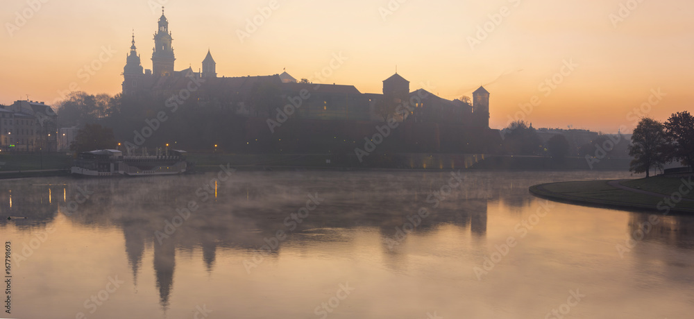 Panorama of Wawel Palace in foggy morning light in Krakow Poland
