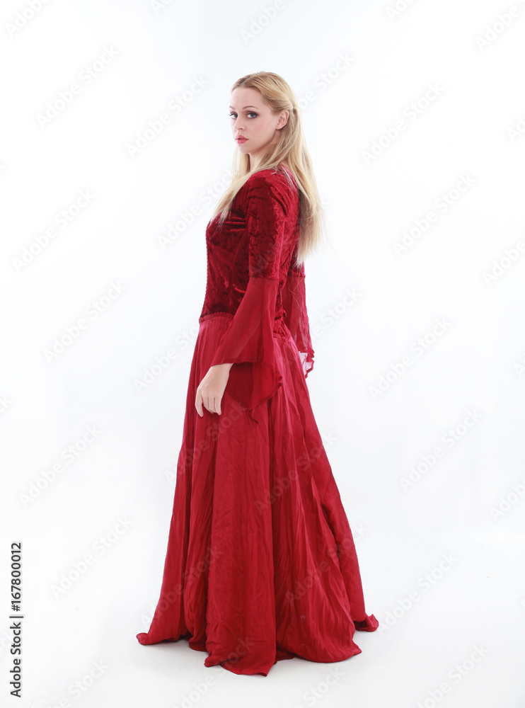 beautiful lady with long blonde hair wearing a red medieval fantasy gown. standing, isolated on white background.