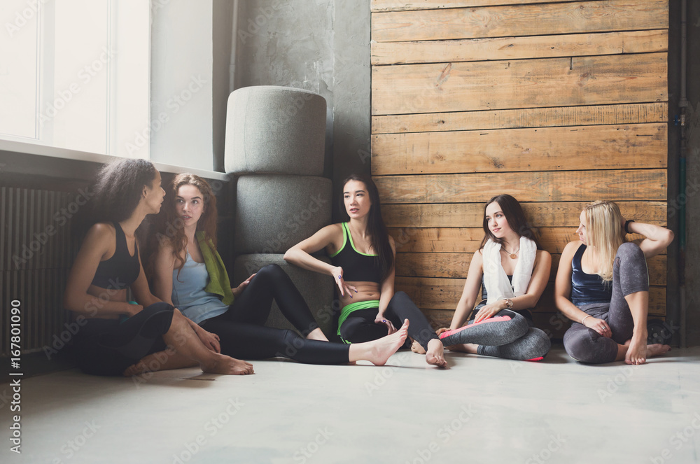 Young girls in sportswear having rest after fitness training Young girls in sportswear having rest after fitness training