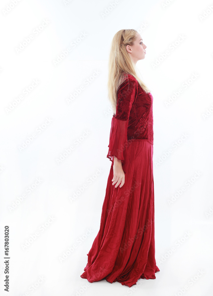 beautiful lady with long blonde hair wearing a red medieval fantasy gown. standing, isolated on white background. beautiful lady with long blonde hair wearing a red medieval fantasy gown. standing, isolated on white background.