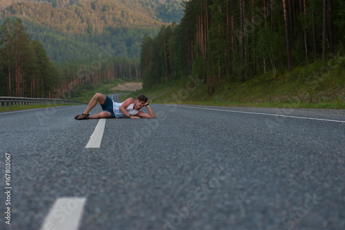 Man laying on the road
