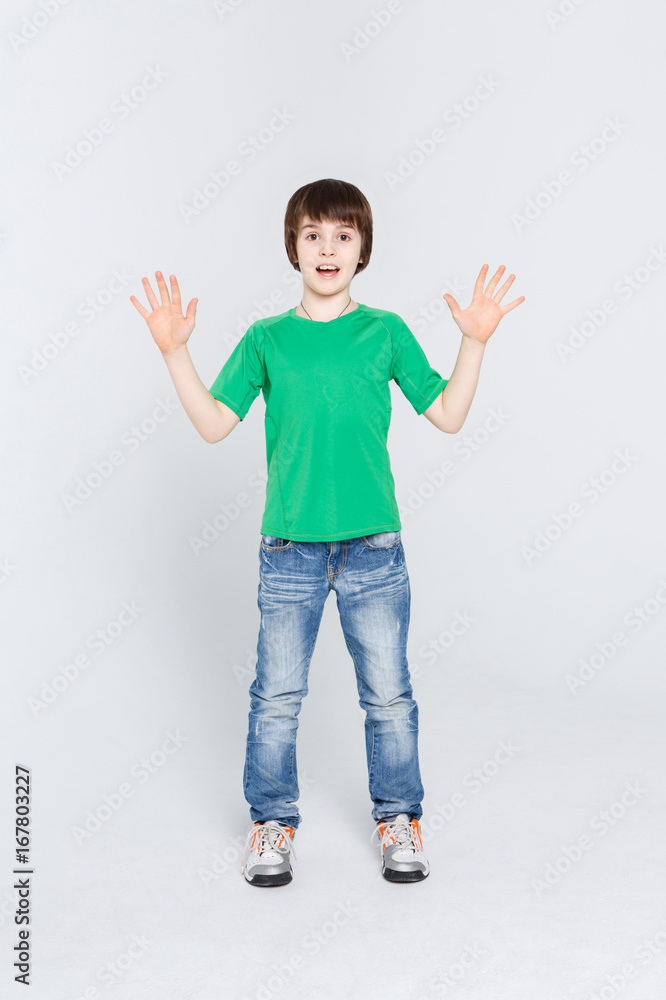 Amazed cute little boy showing his palms on white studio background Amazed cute little boy showing his palms on white studio background