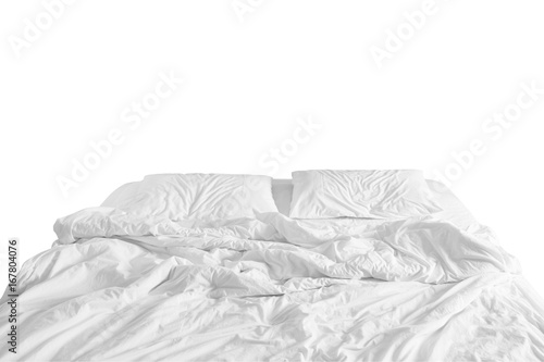 unmade bed with crumpled bed sheet, a blanket and pillows after comfort duvet sleep waking up in the morning.