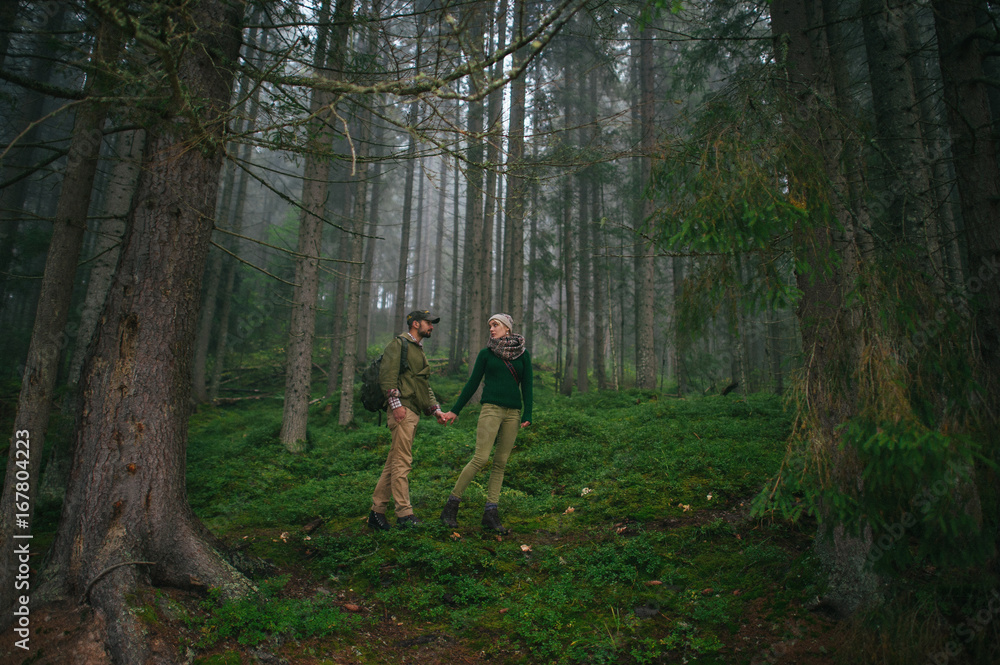 incredibly beautiful and young couple walking in the forest incredibly beautiful and young couple walking in the forest