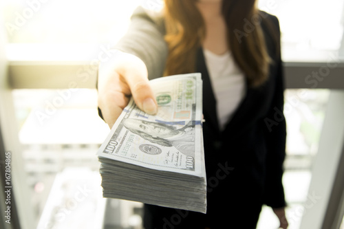 Billede på lærred Business woman is offering cash money.