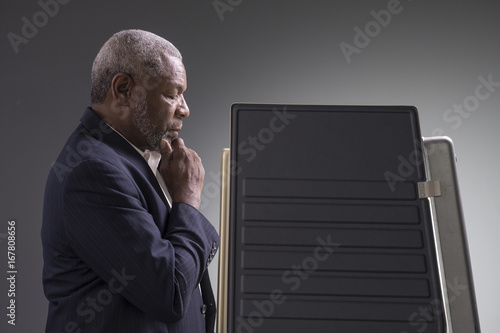 Fotografija Portrait of a black man standing in a voting booth