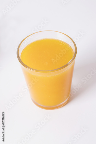 glass with natural orange juice on white background