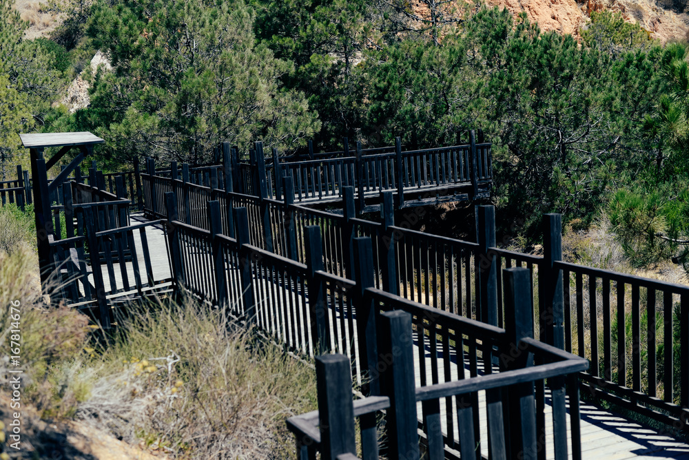 Wooden bridge and natural mountain hillside outdoors view background. Peaceful sunny dream holiday destination