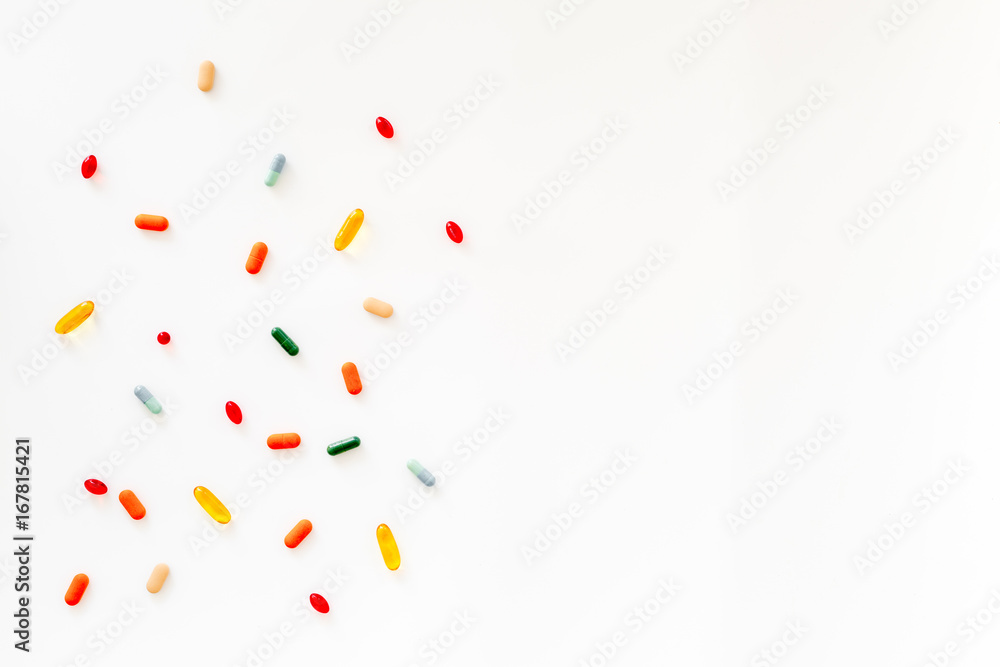 Medicine concept. Colored pills on white background top view copyspace Medicine concept. Colored pills on white background top view copyspace