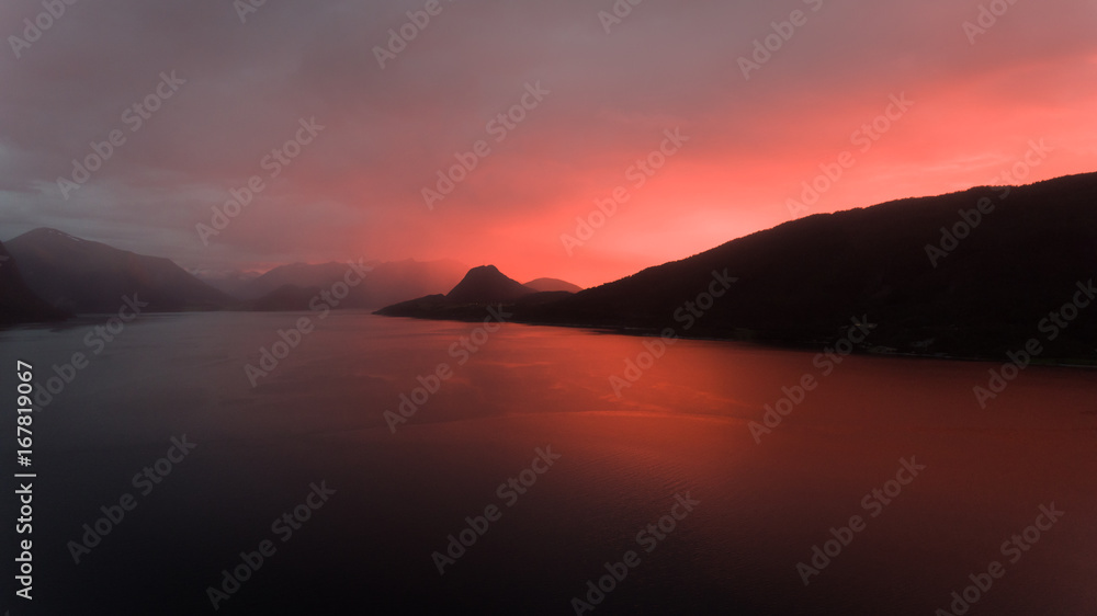 Beautiful red sunset behind the Norwegian Coastline