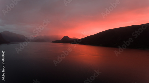 Beautiful red sunset behind the Norwegian Coastline © Amund