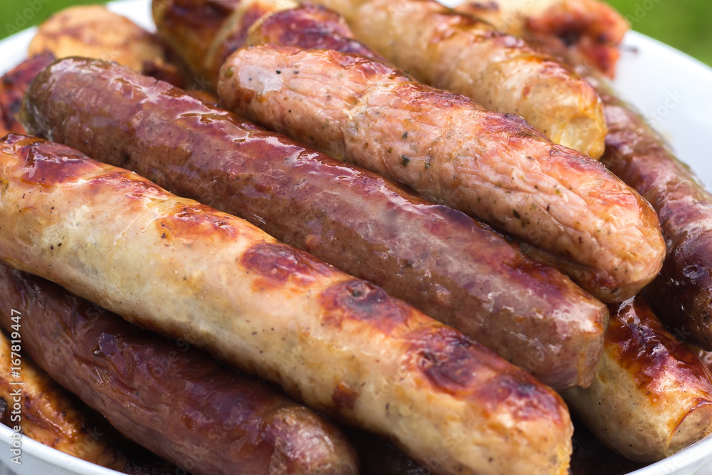 Several freshly prepared sausages. They are prepared on hot coals on the grill. Several freshly prepared sausages. They are prepared on hot coals on the grill.
