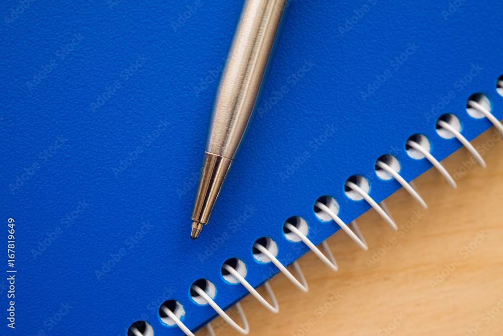 Notebook and pen on a wooden background Notebook and pen on a wooden background