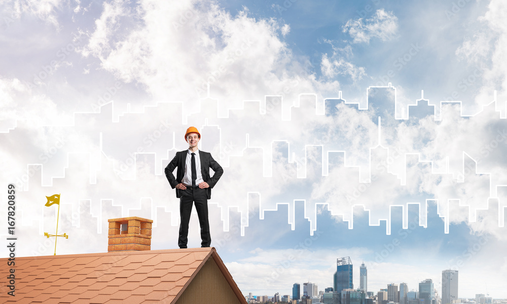 Engineer man standing on roof and looking away. Mixed media Engineer man standing on roof and looking away. Mixed media