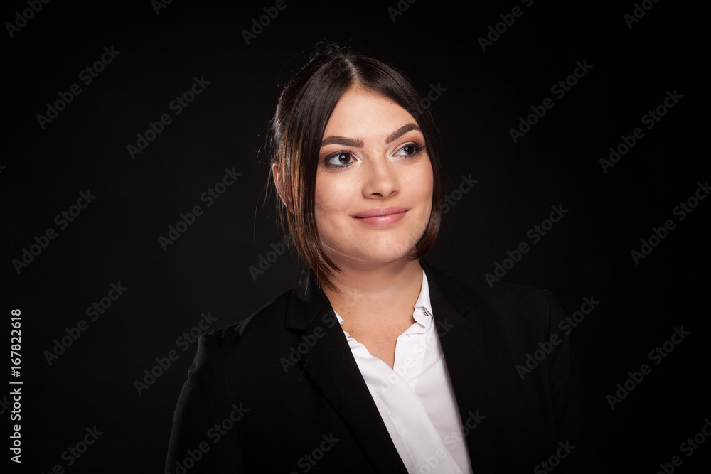 Portrait of beautiful successful businesswoman in studio photo over black background Portrait of beautiful successful businesswoman in studio photo over black background