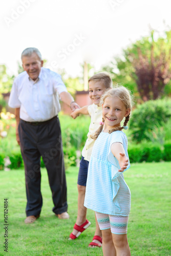 Portrait of happy old grandfather and cute children © spass