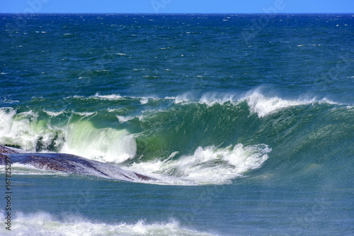 Big  dangerous waves during tropical storm in the green and blue waters of Rio de Janeiro  Brazil