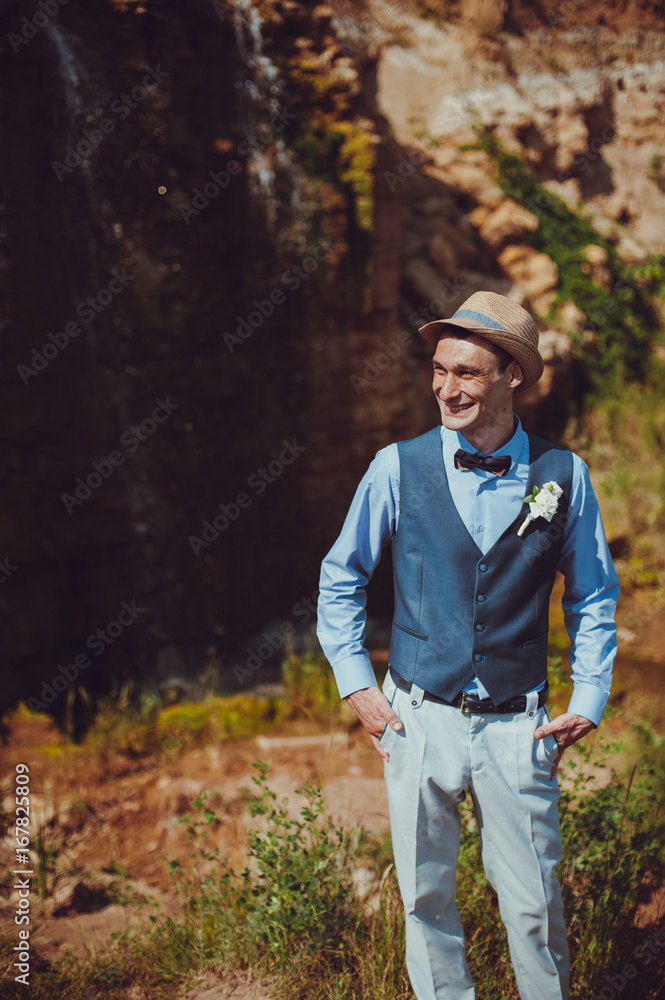Portrait of the groom on a wedding day walk