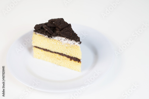 Chocolate cookies oreo cheese cake slice on white dish