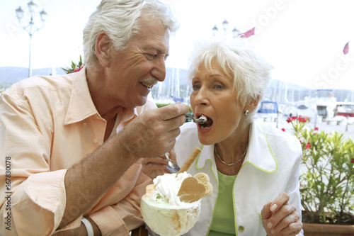 Senior couple enjoy a big cup of ice cream
